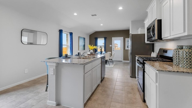 139 Gerber Ln, Boyd, TX 76023 - kitchen with stainless steel appliances, an island with sink, white cabinetry, light tile patterned floors, and recessed lighting