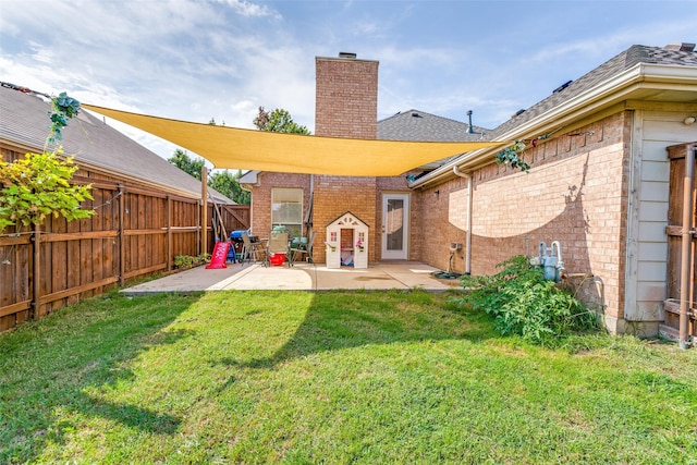 2009 Reddenson Dr, Carrollton, TX 75010 - rear view of house featuring brick siding, a patio, a fenced backyard, and a chimney
