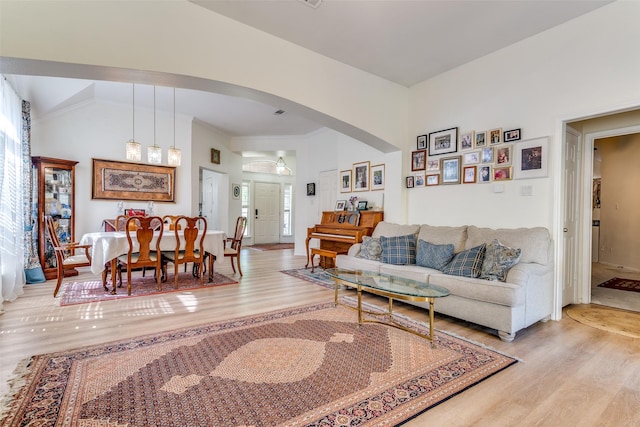 2009 Reddenson Dr, Carrollton, TX 75010 - living room featuring wood finished floors, arched walkways, and healthy amount of natural light