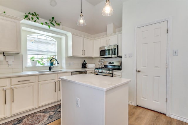 2009 Reddenson Dr, Carrollton, TX 75010 - kitchen featuring stainless steel appliances, tasteful backsplash, light wood-type flooring, pendant lighting, and a center island