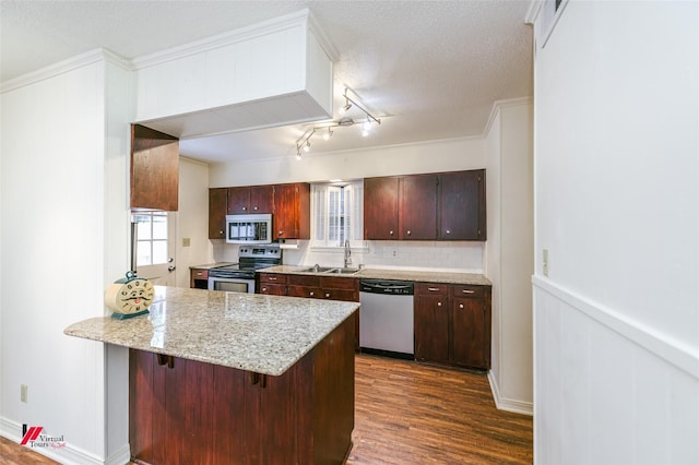 719 Edgemont St, Shreveport, LA 71106 - kitchen featuring stainless steel appliances, a peninsula, dark wood-style floors, a breakfast bar area, and wainscoting