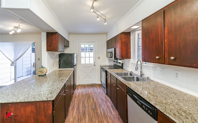 719 Edgemont St, Shreveport, LA 71106 - kitchen with appliances with stainless steel finishes, backsplash, ornamental molding, dark wood-type flooring, and a textured ceiling