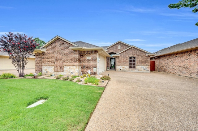210 Oleander Pl, Waxahachie, TX 75165 - ranch-style house featuring stone siding, concrete driveway, a garage, a front lawn, and brick siding