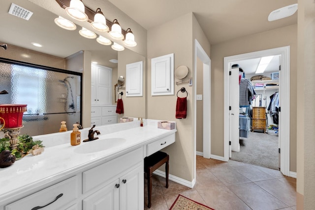 210 Oleander Pl, Waxahachie, TX 75165 - full bath with a stall shower, vanity, a spacious closet, and tile patterned floors