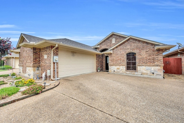 210 Oleander Pl, Waxahachie, TX 75165 - view of front of home with an attached garage, roof with shingles, stone siding, and concrete driveway