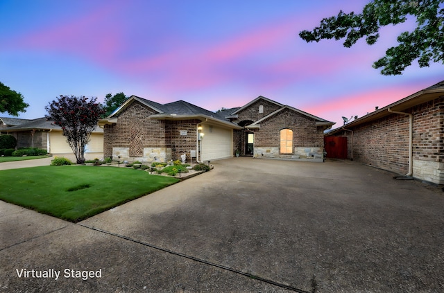 210 Oleander Pl, Waxahachie, TX 75165 - view of front of house with an attached garage, concrete driveway, stone siding, and a yard