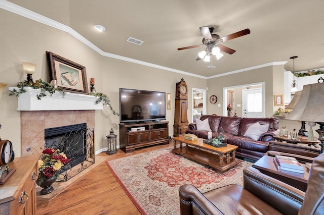 210 Oleander Pl, Waxahachie, TX 75165 - living room featuring a ceiling fan, wood finished floors, a fireplace, and ornamental molding