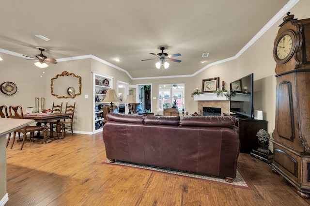 210 Oleander Pl, Waxahachie, TX 75165 - living area featuring ceiling fan, wood finished floors, ornamental molding, and a tiled fireplace