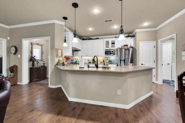 210 Oleander Pl, Waxahachie, TX 75165 - kitchen with appliances with stainless steel finishes, glass insert cabinets, under cabinet range hood, a peninsula, and crown molding