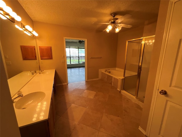 1705 Huntington Dr, Mesquite, TX 75149 - full bathroom featuring a garden tub, a shower stall, double vanity, a ceiling fan, and a textured ceiling