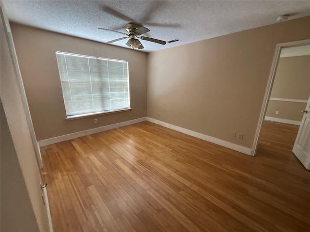1705 Huntington Dr, Mesquite, TX 75149 - spare room featuring ceiling fan, light wood-style flooring, and a textured ceiling