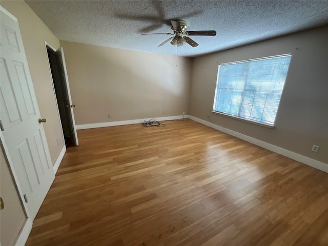 1705 Huntington Dr, Mesquite, TX 75149 - unfurnished room with a ceiling fan, light wood-style flooring, and a textured ceiling
