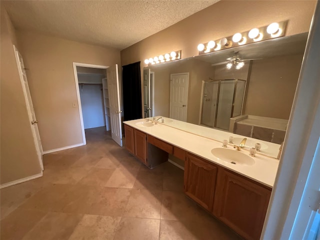 1705 Huntington Dr, Mesquite, TX 75149 - full bath with a shower stall, a textured ceiling, double vanity, a ceiling fan, and a walk in closet