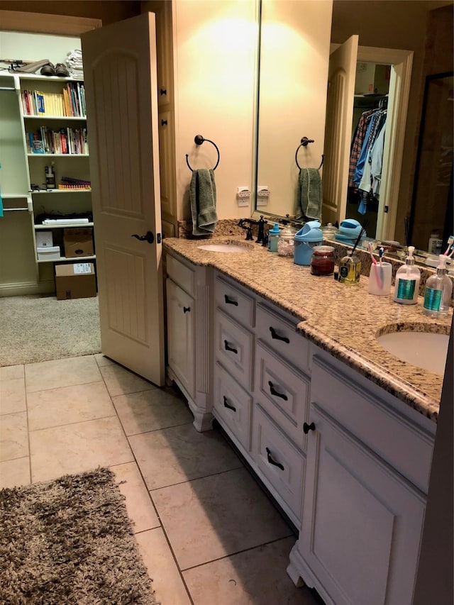 413 Fair Oaks St, Bossier City, LA 71112 - bathroom featuring double vanity, a walk in closet, and tile patterned floors