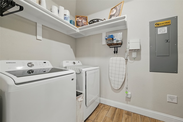 2409 Ross Ave, Fort Worth, TX 76164 - laundry room featuring independent washer and dryer, electric panel, and light wood-type flooring