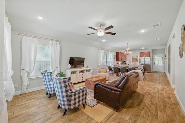 2409 Ross Ave, Fort Worth, TX 76164 - living area featuring light wood finished floors, a chandelier, a ceiling fan, and recessed lighting