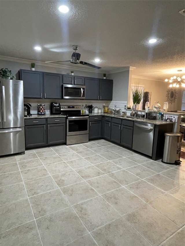 8732 Fox Meadow Way, Fort Worth, TX 76123 - kitchen with appliances with stainless steel finishes, crown molding, gray cabinets, light tile patterned floors, and a peninsula