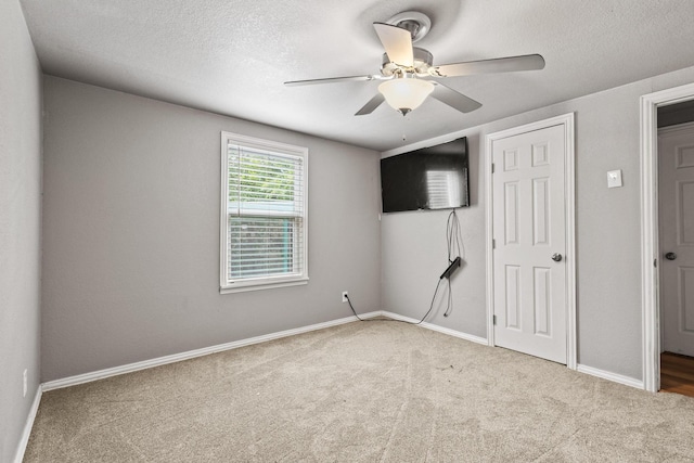 84 Kristin Dr, Pottsboro, TX 75076 - unfurnished bedroom with carpet flooring, a textured ceiling, and ceiling fan
