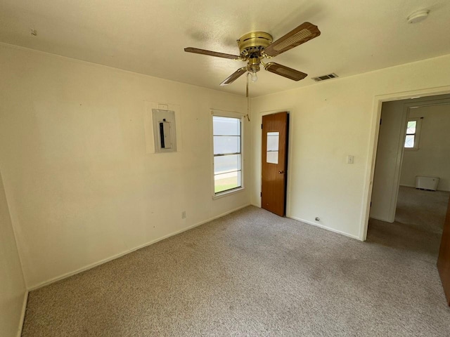 3560 Regal Rd, Fort Worth, TX 76111 - unfurnished room with electric panel, healthy amount of natural light, a ceiling fan, and carpet flooring