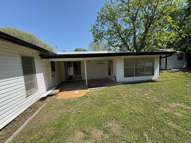 3560 Regal Rd, Fort Worth, TX 76111 - back of property with a lawn and a patio