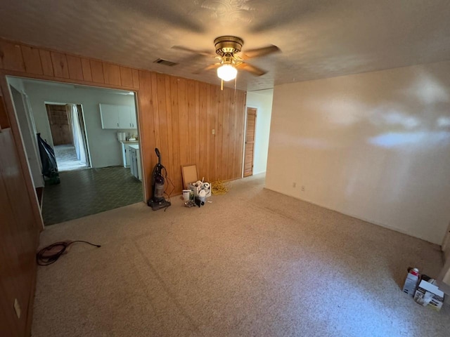 3560 Regal Rd, Fort Worth, TX 76111 - carpeted spare room featuring wooden walls and a ceiling fan