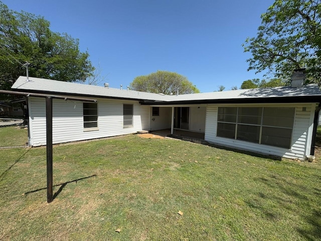 3560 Regal Rd, Fort Worth, TX 76111 - rear view of property featuring a yard and a chimney