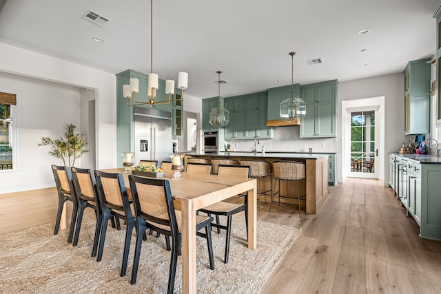 3560 Pleasant Run Cir, Athens, TX 75752 - dining area with light wood-style flooring, recessed lighting, and a chandelier