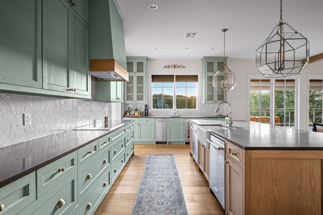3560 Pleasant Run Cir, Athens, TX 75752 - kitchen with green cabinetry, dishwasher, light wood-style floors, an island with sink, and recessed lighting