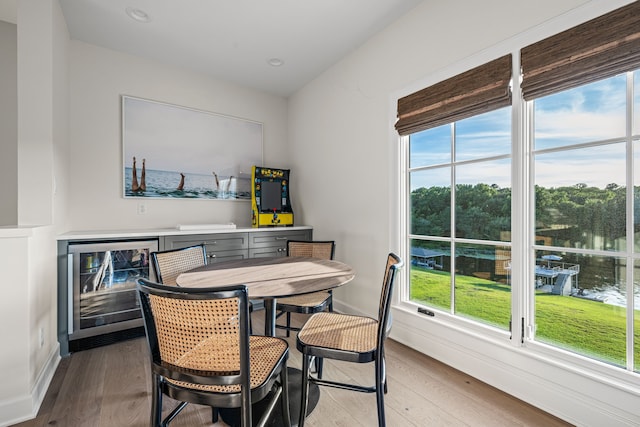 3560 Pleasant Run Cir, Athens, TX 75752 - dining area with wine cooler, healthy amount of natural light, wood finished floors, and recessed lighting