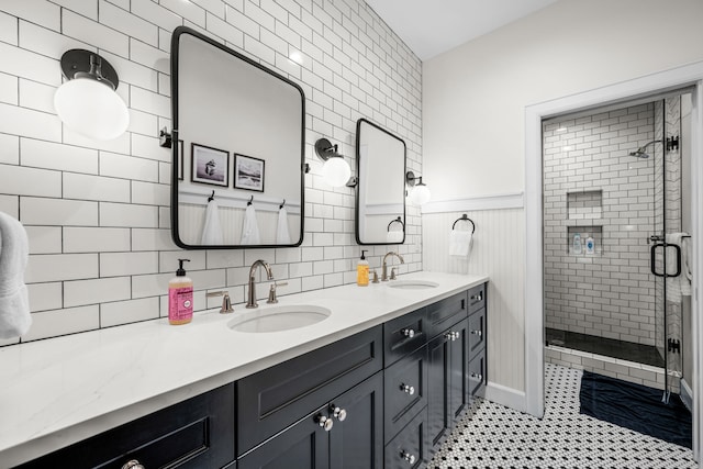 3560 Pleasant Run Cir, Athens, TX 75752 - bathroom featuring double vanity, a stall shower, tile patterned flooring, and wainscoting