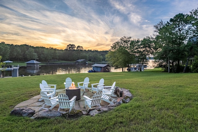 3560 Pleasant Run Cir, Athens, TX 75752 - yard at dusk with an outdoor fire pit, a water view, and a lawn