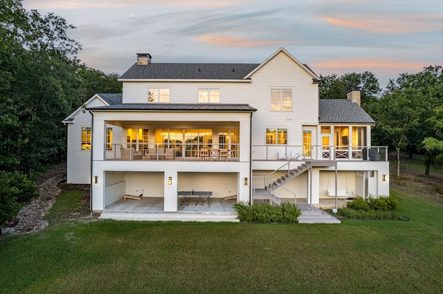 3560 Pleasant Run Cir, Athens, TX 75752 - back of house featuring a chimney, a patio, a standing seam roof, and stairs