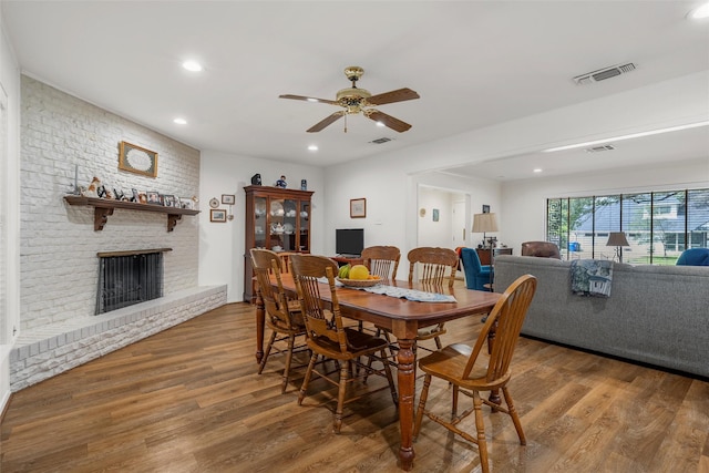 5512 Lake Charles Dr, Waco, TX 76710 - dining room featuring wood finished floors, recessed lighting, a ceiling fan, and a fireplace