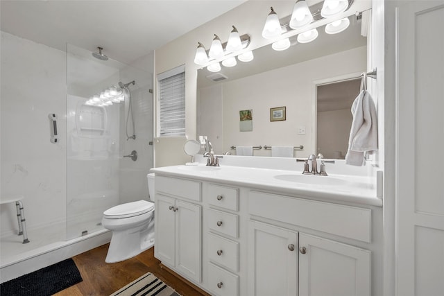 5512 Lake Charles Dr, Waco, TX 76710 - bathroom featuring a stall shower, double vanity, and wood finished floors