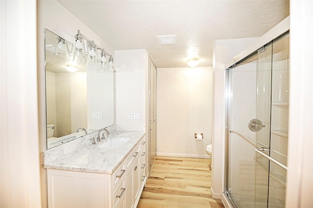 103 Wise St, Nocona, TX 76255 - full bath featuring wood finished floors, vanity, and a shower stall