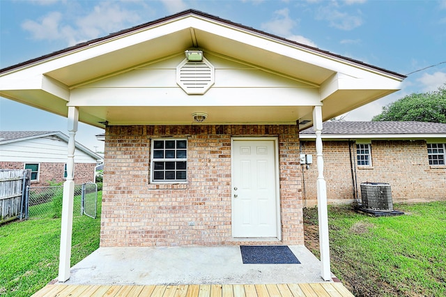 103 Wise St, Nocona, TX 76255 - property entrance featuring brick siding and a wooden deck