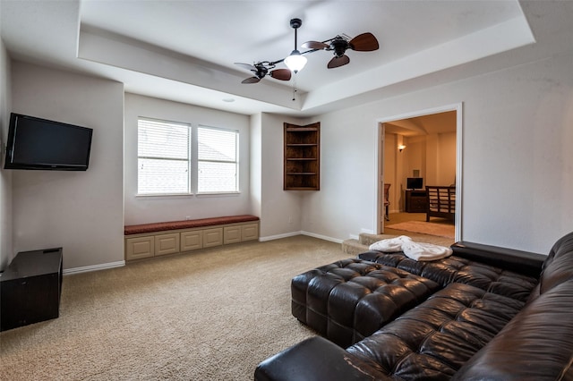 7601 Willowbend Dr, Mckinney, TX 75071 - living area featuring a raised ceiling, a ceiling fan, and light colored carpet