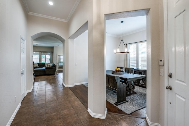 7601 Willowbend Dr, Mckinney, TX 75071 - foyer entrance with arched walkways, ornamental molding, dark tile patterned floors, and a chandelier