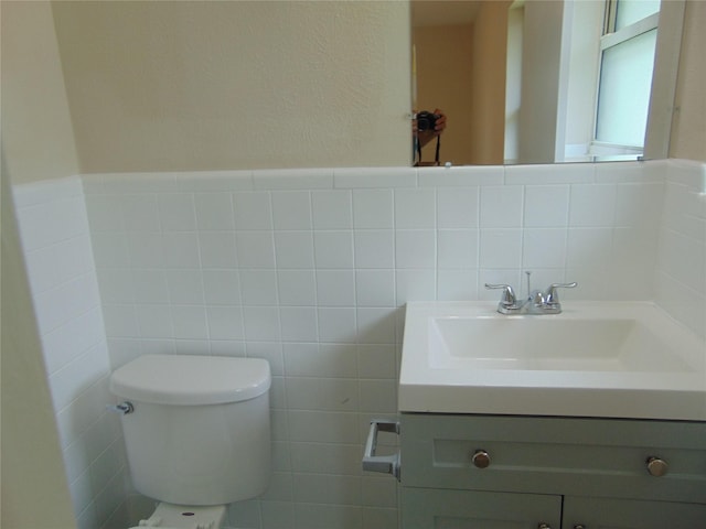 802 Acton Ave, Duncanville, TX 75137 - bathroom featuring vanity, tile walls, and wainscoting
