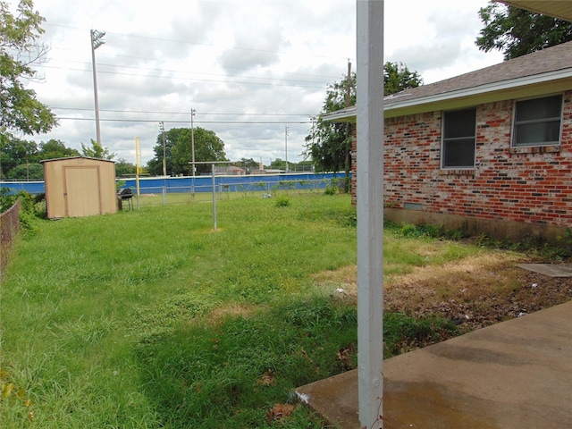 802 Acton Ave, Duncanville, TX 75137 - fenced backyard featuring a storage unit