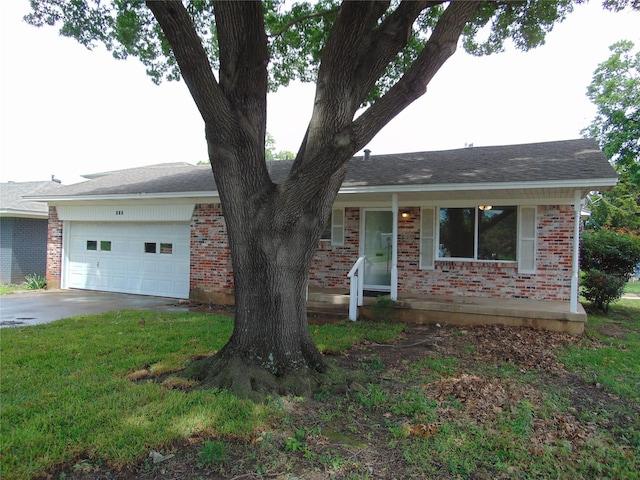 802 Acton Ave, Duncanville, TX 75137 - view of front of property featuring brick siding, a garage, concrete driveway, and a front lawn
