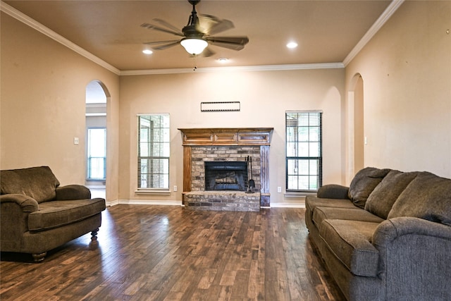 104 Coldwater Creek Ln, Weatherford, TX 76088 - living room with arched walkways, dark wood finished floors, ceiling fan, a fireplace, and healthy amount of natural light
