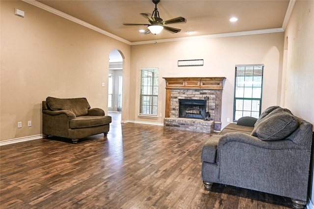 104 Coldwater Creek Ln, Weatherford, TX 76088 - living room featuring arched walkways, ceiling fan, dark wood-style floors, a brick fireplace, and ornamental molding