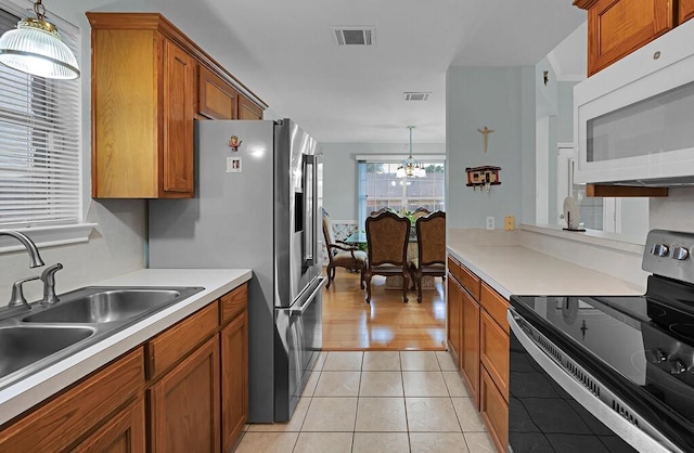 308 Greystone Dr, Lorena, TX 76655 - kitchen featuring electric range, white microwave, brown cabinets, and light countertops