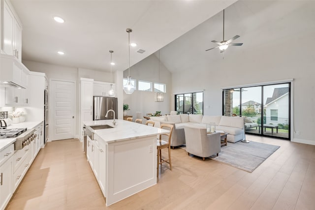 2232 Offerande Dr, Fort Worth, TX 76008 - kitchen featuring appliances with stainless steel finishes, open floor plan, high vaulted ceiling, a breakfast bar area, and a ceiling fan