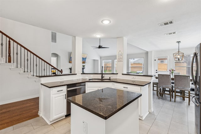 2708 Ferdinand, Grand Prairie, TX 75054 - kitchen with appliances with stainless steel finishes, a center island, light tile patterned flooring, white cabinets, and ceiling fan