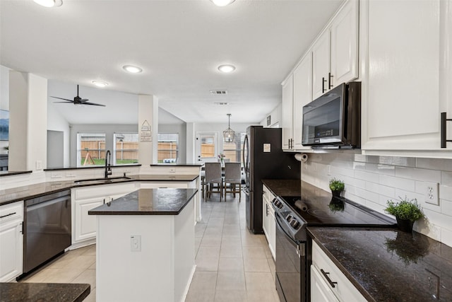 2708 Ferdinand, Grand Prairie, TX 75054 - kitchen with electric range, black microwave, dishwasher, tasteful backsplash, and white cabinetry