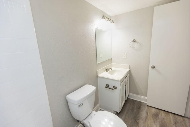 520 Hawthorne Dr, Allen, TX 75002 - bathroom with vanity, wood finished floors, and a textured wall