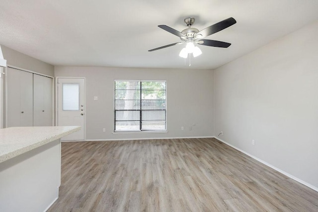 520 Hawthorne Dr, Allen, TX 75002 - unfurnished living room featuring light wood finished floors and a ceiling fan