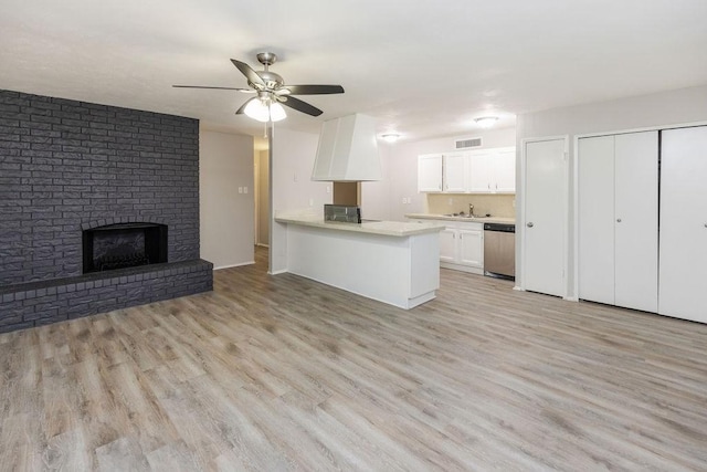 520 Hawthorne Dr, Allen, TX 75002 - kitchen with stainless steel dishwasher, a ceiling fan, light wood-type flooring, and white cabinets